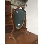 A shield shaped toilet mirror Catalogue only, live bidding available via our website. Please note if