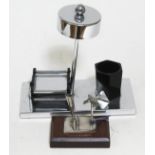 An Art Deco smoker's set and a vintage chromed pen holder on wooden plinth.