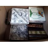 A box of various Victorian tiles.