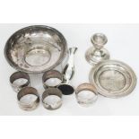 A mixed lot comprising a set of five white metal serviette rings, a hallmarked silver dish and