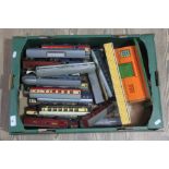 A box of mainly Tri-ang and Hornby Dublo model railway coaches and buildings.