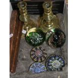 A pair of brass candle sticks and five paperweights including Caithness