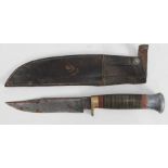 A vintage scout type knife with leather scabbard.