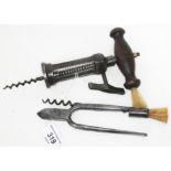 A 19th century rack and pinion corkscrew with wooden handle and brush together with a pair of