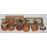 A set of continental carved wooden serviette rings and an Indian Vizagaptam box containing carved