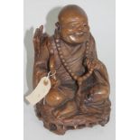 A carved wooden seated buddha, height 25cm.