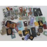 A box of foreign military medals and badges.