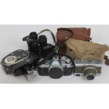 A box of cameras including a Canon AE-1, A Werra MX V, a Quartz Zoom cine cam etc.