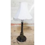 A 1920s twist oak table lamp with shade, height 57cm.