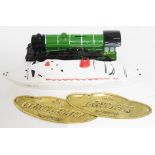 A money box in shape of locomotive, a ceramic ornament in shape of cruiser and two brass door plates