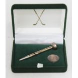 A cased hallmarked silver golf tee and marker.