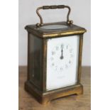 A brass carriage clock, signed 'R Sutton Paris'.