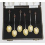 A cased set of six hallmarked silver and enamel Art Deco bean spoons.