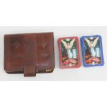 Two sets of WWII victory playing cards within leather case.