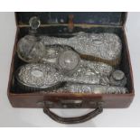 A case containing hallmarked silver dressing table wares.