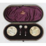 A pair of Victorian hallmarked silver salts with box and spoons.