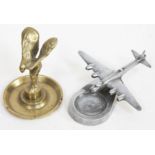 A brass Spirit of Ecstasy ash tray and a cast aluminium ashtray with mounted B52 bomber.