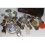 A wooden box of collectables including badges, coins etc