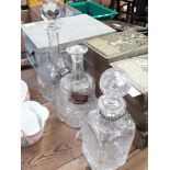 A group of three glass decanters including two etched one marked by Thomas Webb.