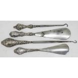 Hallmarked silver handled shoe horns and button hooks.
