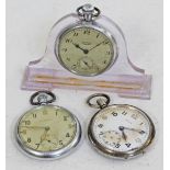 Two G.S.T.P. military pocket watches and chrome services pocket watch in lucite stand
