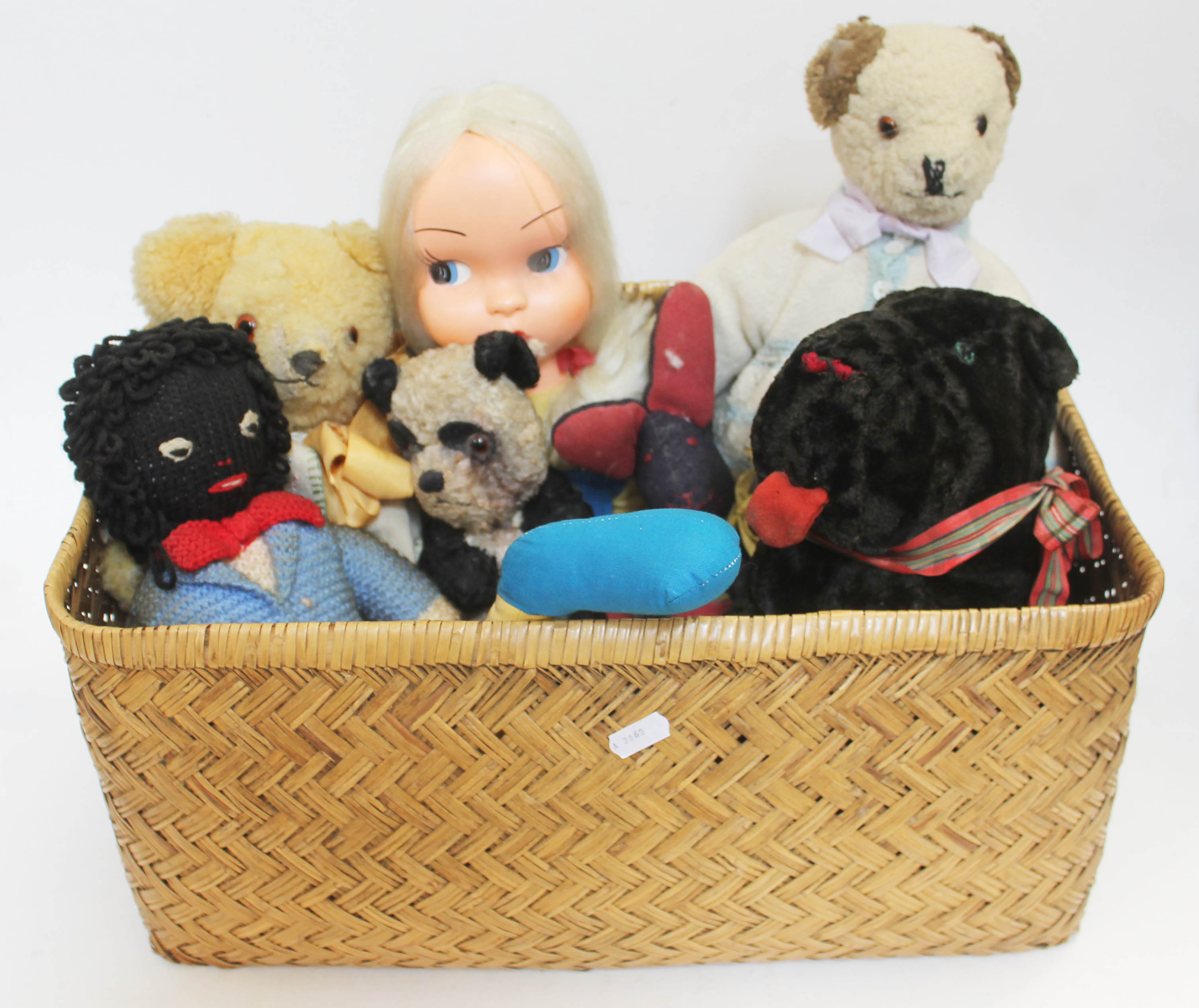 A basket of vintage soft toys.