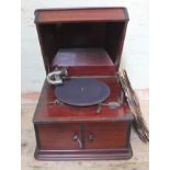 A table gramophone with various 78s.