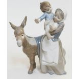 A Lladro figure depicting a woman holding a child and a donkey, height 25cm.
