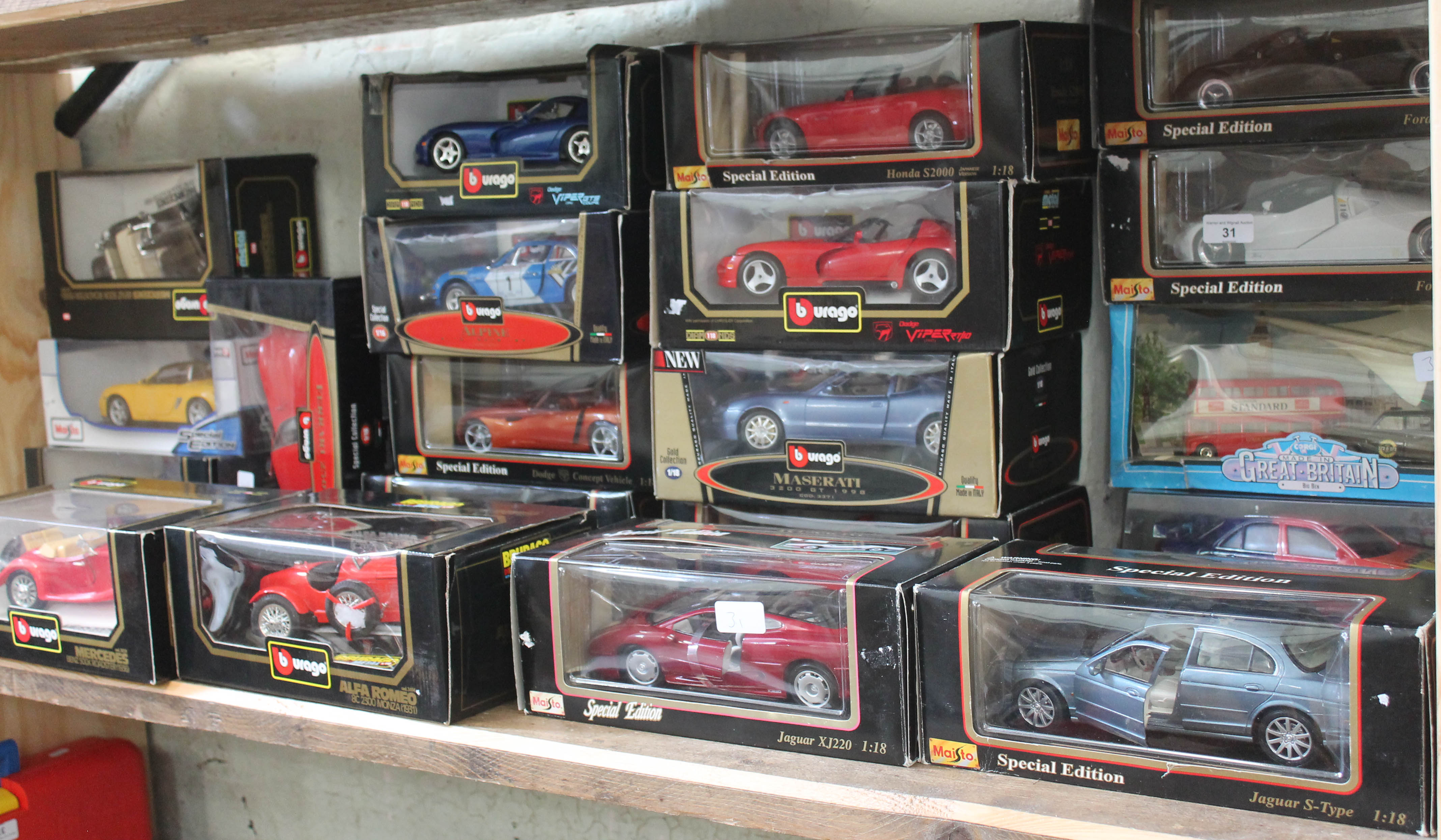 A collection of 20 boxed Burago, Maisto & MCT 1:18 & 1:16 scale die cast model vehicles and a