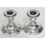 A pair of hallmarked silver candlesticks.