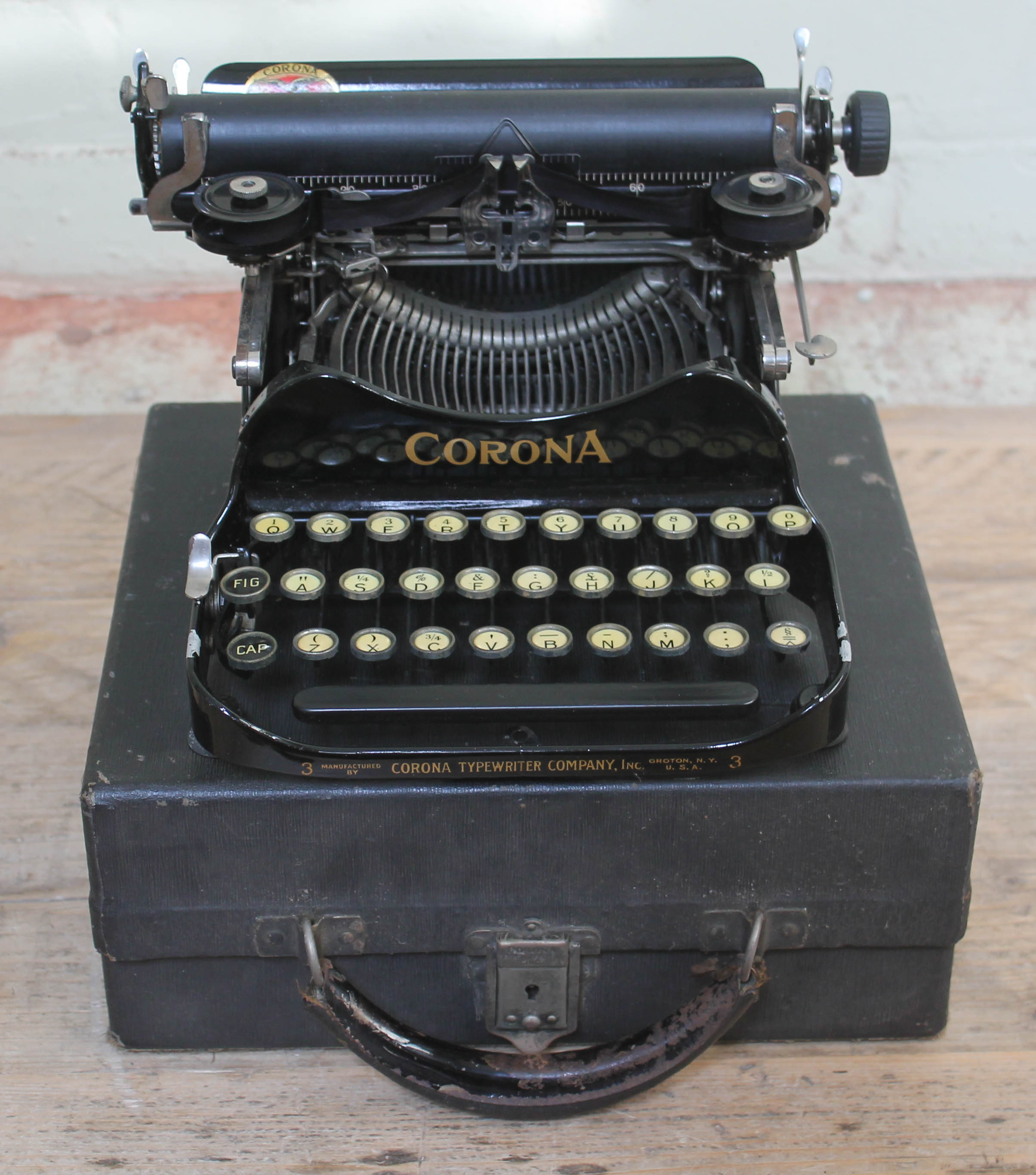 A Corona portable typewriter with case.