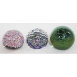 A group of three glass paper weights comprising a French Baccarat with single layer of twisted