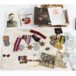 A wooden cigar box of various medals and badges including a WWI pair awarded to Frederick James