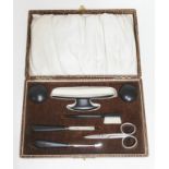 A cased ebony manicure set.