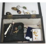 A wooden box containing various antique and vintage stick pins etc.