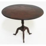 A Georgian "Isle of Man" miniature tripod table with cast iron base formed as three legs and round