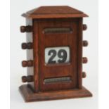 An oak perpetual calendar, height 17cm.