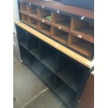 A large cubby hole counter base on castors with primary school style coat hook stand also with lower