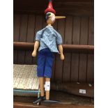 A wooden musical Pinnochio figure Catalogue only, live bidding available via our website. If you