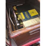 A tin trunk containing various books to include Bible. Catalogue only, live bidding available via
