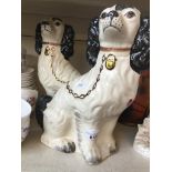 A pair of Staffordshire pottery Spaniels Catalogue only, live bidding available via our website.