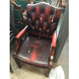 An oxblood leather buttoned back armchair Catalogue only, live bidding available via our website. If