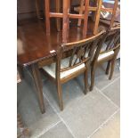 A mahogany dining table and four chairs Catalogue only, live bidding available via our website. If