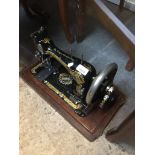 A vintage Singer hand cranked sewing machine Catalogue only, live bidding available via our website.