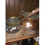 A copper cauldron and 3 copper and brass pans Catalogue only, live bidding available via our