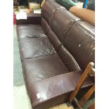 A three seater brown faux leather sofa Catalogue only, live bidding available via our website. If