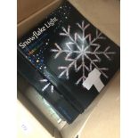 A box with snowflake lights, books, old newspapers, etc Catalogue only, live bidding available via