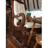 A 19th century mahogany rocking chair with cream fleur de lys button back upholstery Catalogue only,