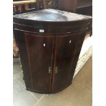 A mahogany bow front corner cupboard Catalogue only, live bidding available via our website. If