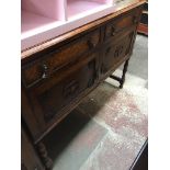 An oak sideboard Catalogue only, live bidding available via our website. If you require P&P please